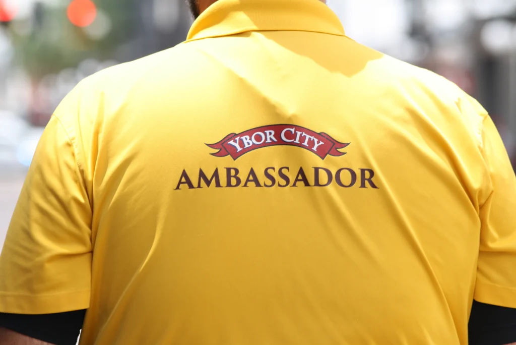 Back of a yellow Ybor City Ambassador polo shirt