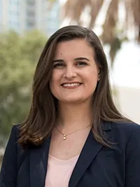 Kristen, smiling woman with long brown hair in a navy blazer