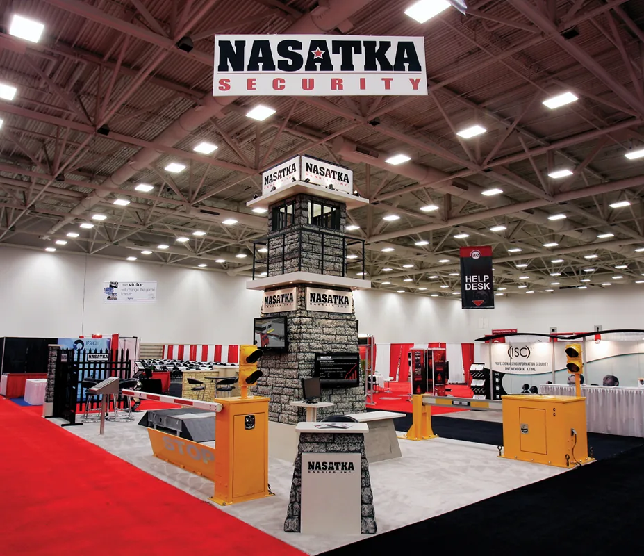 Nasatka Security trade show booth at ASIS 2010 with a stone tower and barriers