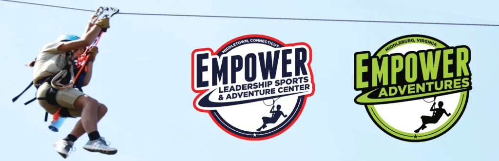 Zip line rider beside Empower Sports and Adventure Center and Empower Adventures logos