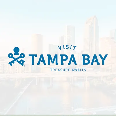 Visit Tampa Bay logo over a blurred city skyline