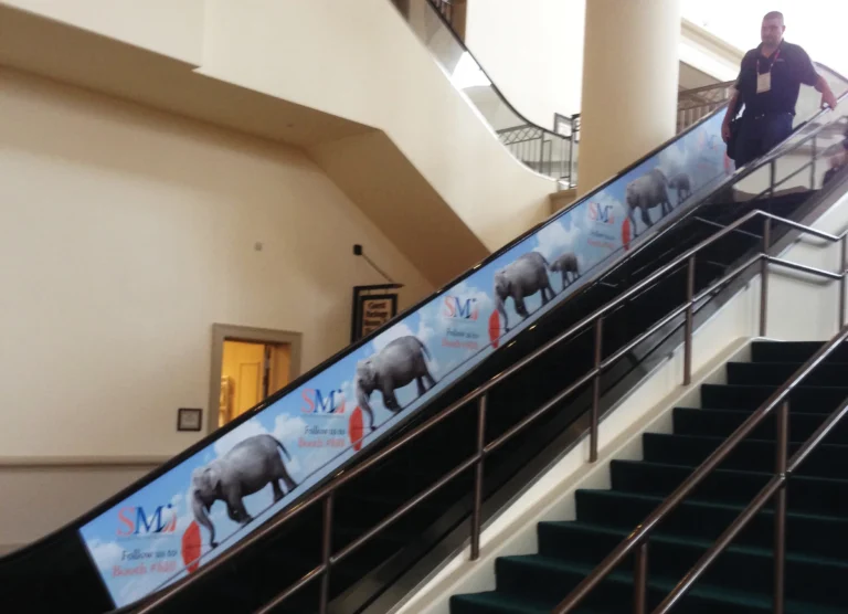 Escalator side panel wrapped with a printed elephant and animal graphic
