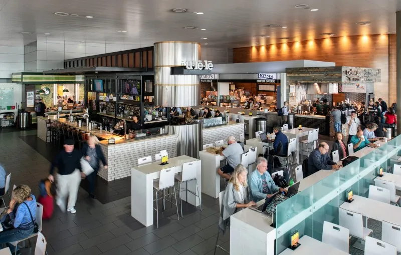 Crowded airport restaurant with bar seating in Airside C seen from above