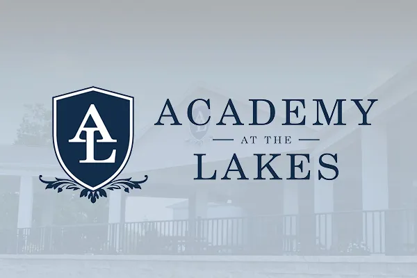Academy at the Lakes logo with navy shield crest
