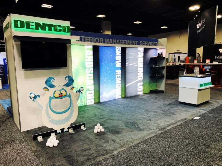 Dentco trade show booth with cartoon mascot and snowballs