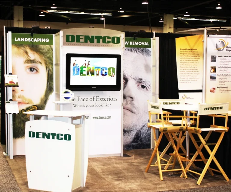 Dentco trade show booth with face graphics and monitor