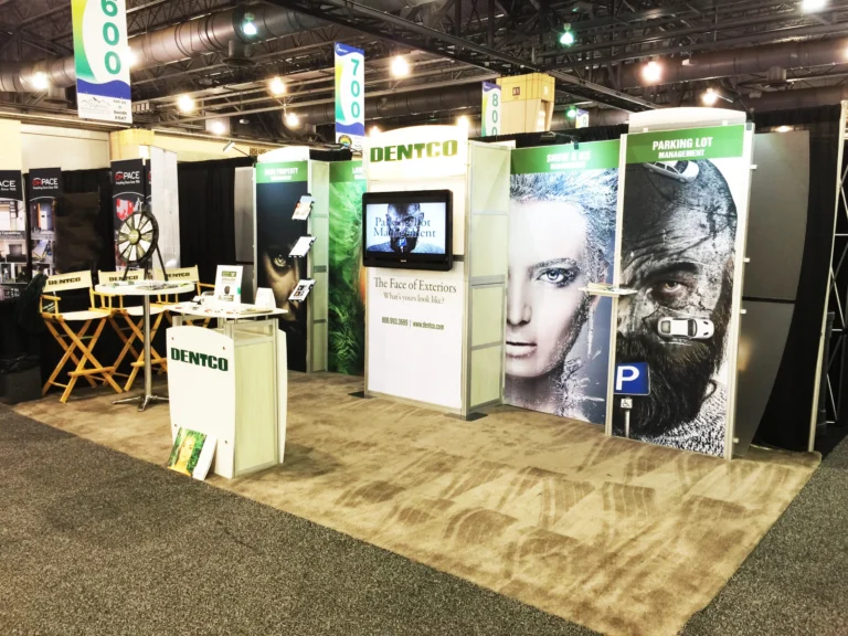 Dentco trade show booth with printed banner walls and director chairs