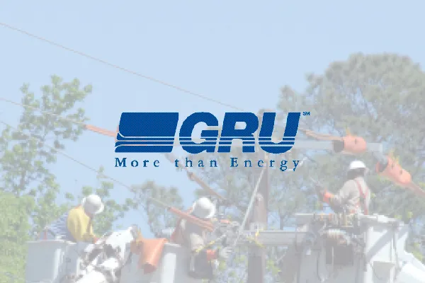 GRU logo, More than Energy, over a photo of utility workers
