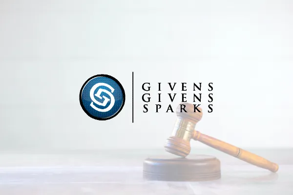 Givens Givens Sparks logo over a gavel on a light background