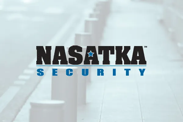 Nasatka Security logo over a faded photo of bollards along a walkway
