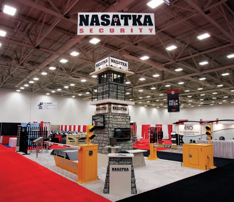 Nasatka Security trade show booth with a stone watchtower display and security equipment