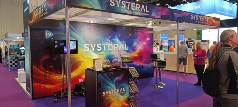 Systeral trade show booth with colorful printed backdrop