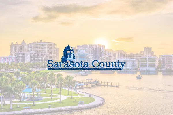 Sarasota County logo over a sunset waterfront skyline