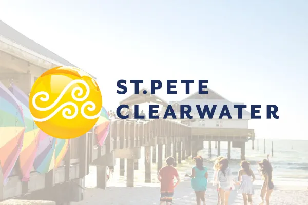 St. Pete Clearwater logo over a beach pier with people walking