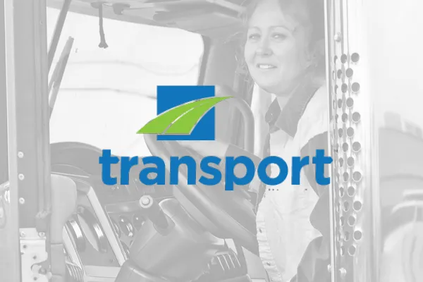 Transport logo over a faded photo of a truck driver in a cab