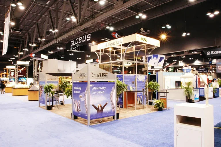 Wide view of exhibit hall with several trade show booths