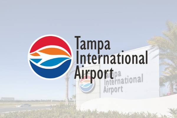 Tampa International Airport logo faded over a photo of the airport sign