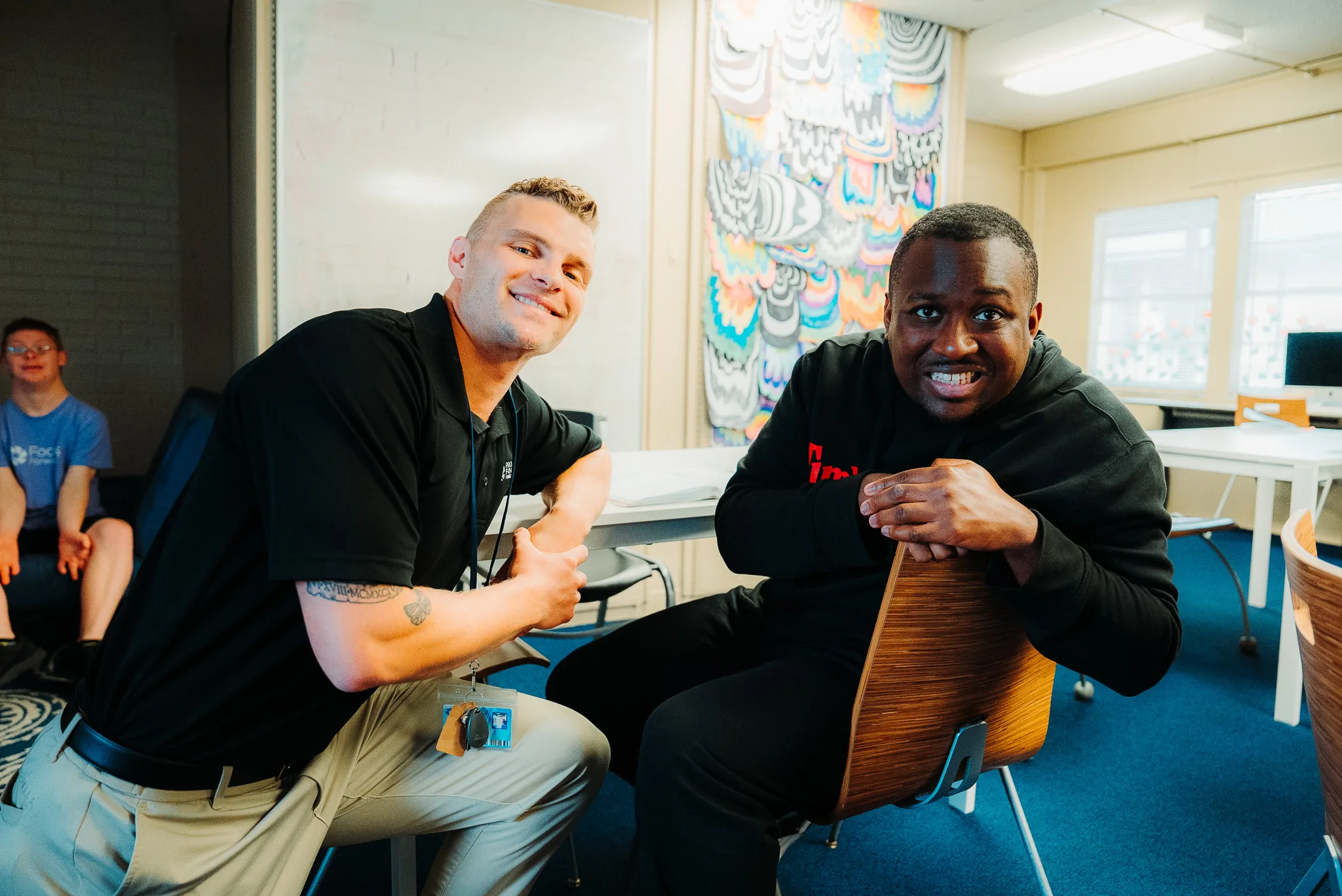 Two men smiling and posing together indoors at Focus Academy