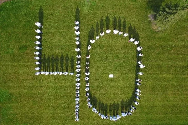 DENTCO celebrates 40 years, aerial view of people forming the number 40 on a lawn