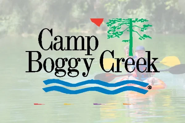 Camp Boggy Creek logo over a faded lakeside photo