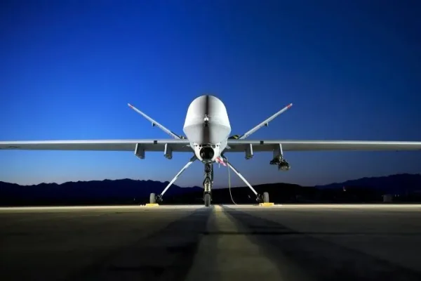Unmanned military drone aircraft on a runway at dusk