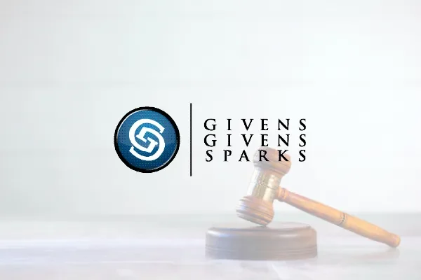 Givens Givens Sparks logo over a gavel on a light background