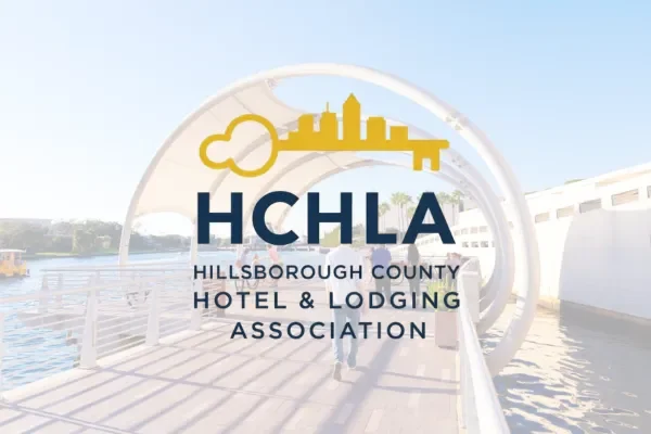 HCHLA Hillsborough County Hotel and Lodging Association logo over a waterfront walkway
