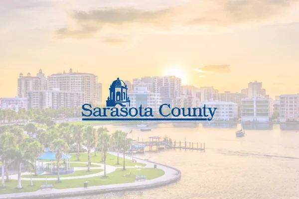 Sarasota County logo over a sunset waterfront skyline