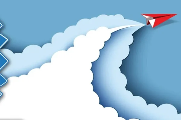 Signpost labeled Mission, Strategy, Vision, Planning, Direction beside a paper airplane and clouds