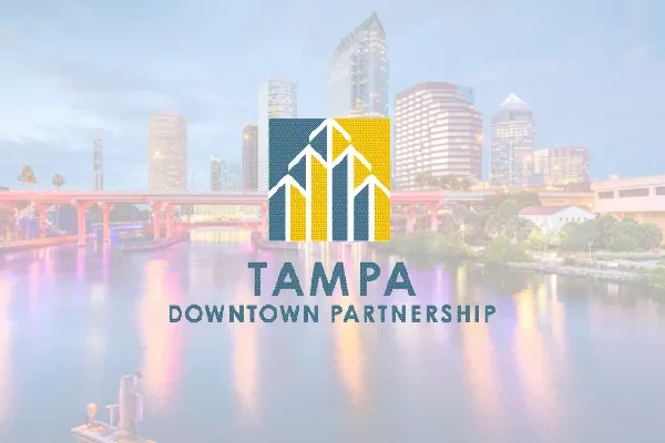 Tampa Downtown Partnership logo over a dusk photo of the riverfront skyline