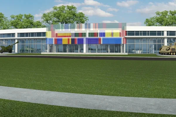 Rendering of a low modern building with colorful panels beyond a grass lawn